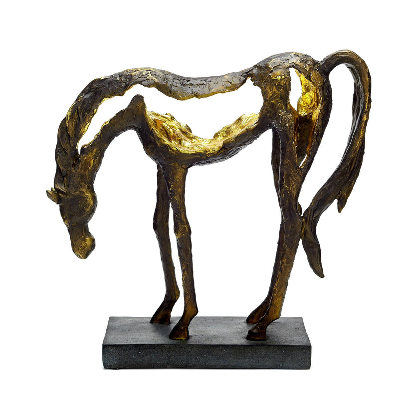 Grazing horse sculpture with a lowered head, flowing silhouette and bronze finish with golden highlights