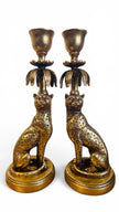 Pair of antique gold leopard candlestick holders on a white background